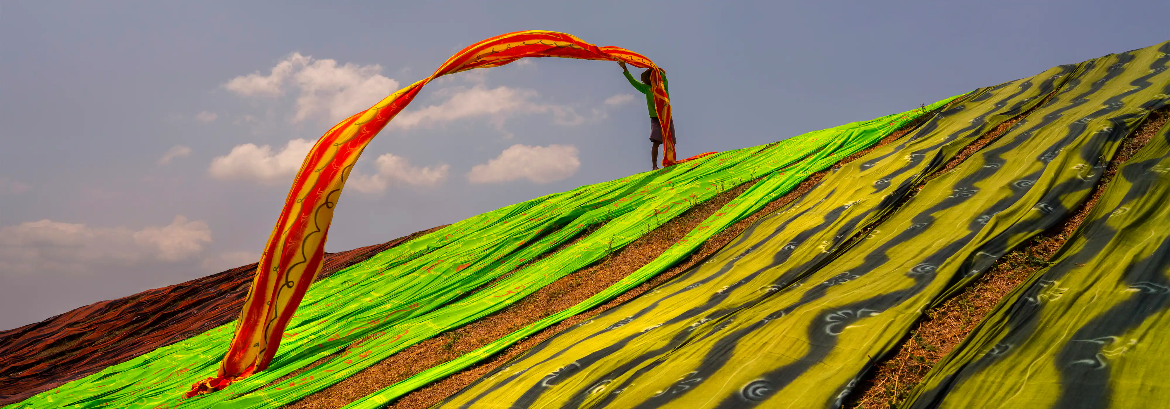 Shot with the FE 24mm F1.4 GM and the Alpha 7R III, this photo captures the motion of a local flinging a fabric in the air in perfect sharpness